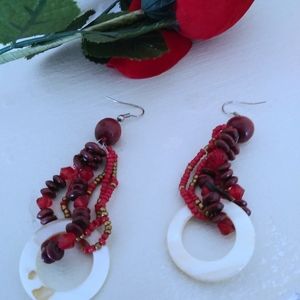 Red beaded earring with white circle